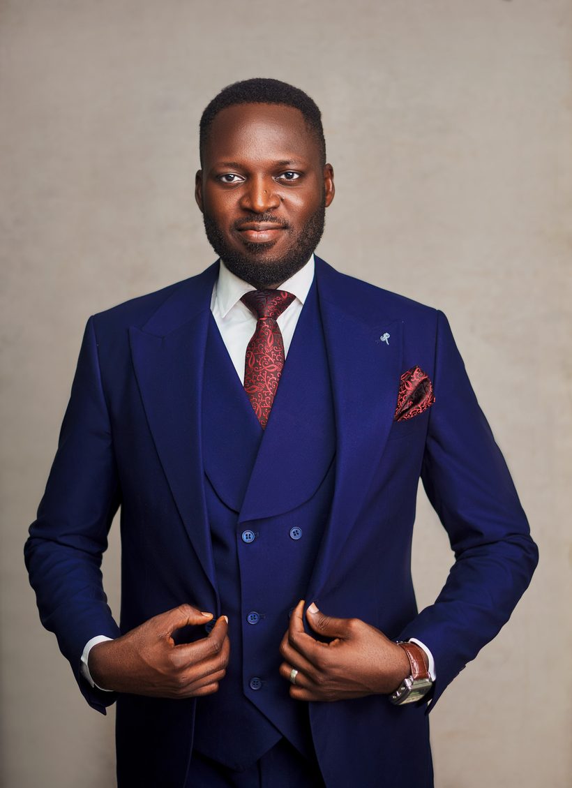 Tope Olowoporoku, founder of Sacred & Satisfied, in a navy three-piece suit